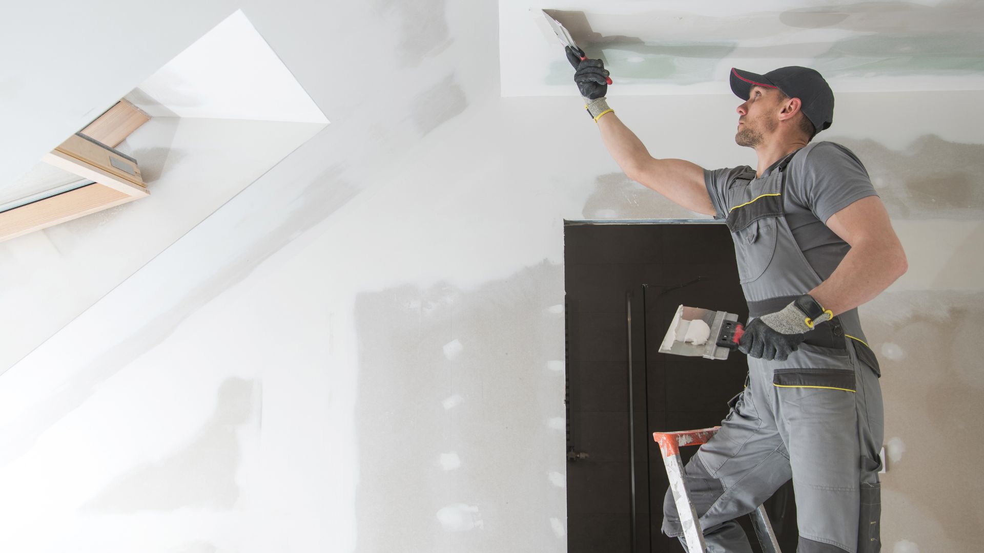 maintenance worker repairing a ceiling
